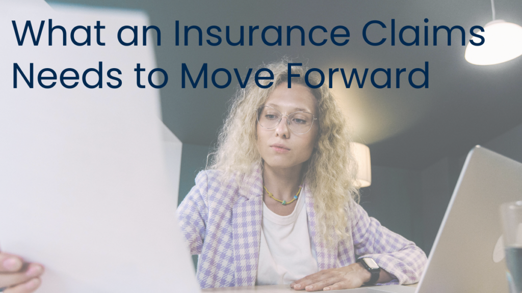 Homeowner reviewing documents on a laptop at a dining table, representing preparation and organization before an insurance claim